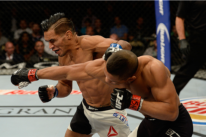 LAS VEGAS, NV - JULY 12: (R-L) Maximo Blanco punches Mike De La Torre in their featherweight bout during the Ultimate Fighter Finale inside MGM Grand Garden Arena on July 12, 2015 in Las Vegas, Nevada. (Photo by Brandon Magnus/Zuffa LLC/Zuffa LLC via Ge