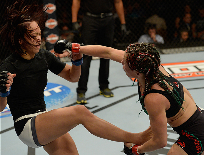 LAS VEGAS, NV - JULY 12: (R-L) Angela Magana punches Michelle Waterson in their women's strawweight bout during the Ultimate Fighter Finale inside MGM Grand Garden Arena on July 12, 2015 in Las Vegas, Nevada. (Photo by Brandon Magnus/Zuffa LLC/Zuffa LLC