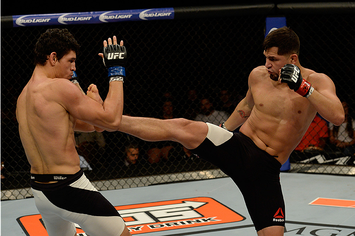 LAS VEGAS, NV - JULY 12: (R-L) Jorge Masvidal kicks Cezar Ferreira in their welterweight bout during the Ultimate Fighter Finale inside MGM Grand Garden Arena on July 12, 2015 in Las Vegas, Nevada. (Photo by Brandon Magnus/Zuffa LLC/Zuffa LLC via Getty