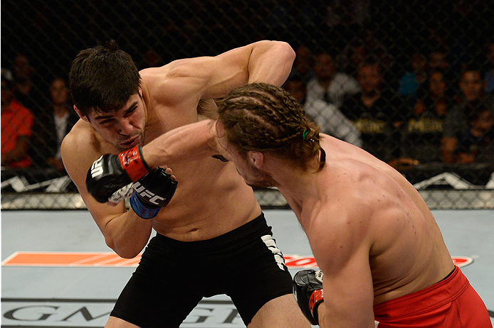 LAS VEGAS, NV - JULY 12: (L-R) Vicente Luque punches Michael Graves in their welterweight bout during the Ultimate Fighter Finale inside MGM Grand Garden Arena on July 12, 2015 in Las Vegas, Nevada. (Photo by Brandon Magnus/Zuffa LLC/Zuffa LLC via Getty