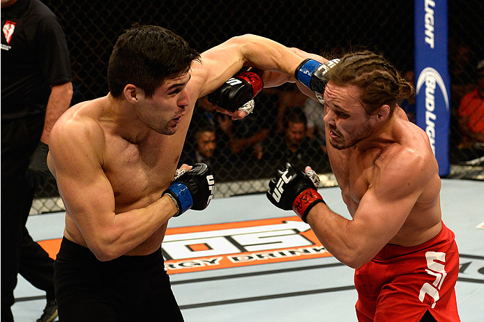 LAS VEGAS, NV - JULY 12: (L-R) Vicente Luque punches Michael Graves in their welterweight bout during the Ultimate Fighter Finale inside MGM Grand Garden Arena on July 12, 2015 in Las Vegas, Nevada. (Photo by Brandon Magnus/Zuffa LLC/Zuffa LLC via Getty