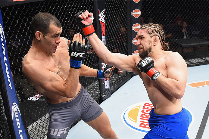 LAS VEGAS, NV - DECEMBER 11: (R-L) Chris Gruetzemacher punches Abner Lloveras in their lightweight bout during the TUF Finale event inside The Chelsea at The Cosmopolitan of Las Vegas on December 11, 2015 in Las Vegas, Nevada. (Photo by Jeff Bottari/Zuff
