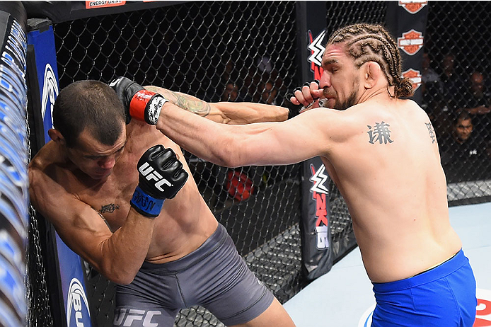 LAS VEGAS, NV - DECEMBER 11: (R-L) Chris Gruetzemacher punches Abner Lloveras in their lightweight bout during the TUF Finale event inside The Chelsea at The Cosmopolitan of Las Vegas on December 11, 2015 in Las Vegas, Nevada. (Photo by Jeff Bottari/Zuff