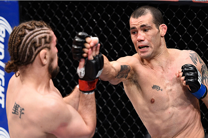 LAS VEGAS, NV - DECEMBER 11: (R-L) Abner Lloveras punches Chris Gruetzemacher in their lightweight bout during the TUF Finale event inside The Chelsea at The Cosmopolitan of Las Vegas on December 11, 2015 in Las Vegas, Nevada. (Photo by Jeff Bottari/Zuff