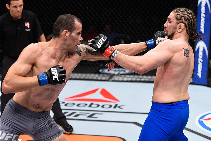 LAS VEGAS, NV - DECEMBER 11: (L-R) Abner Lloveras punches Chris Gruetzemacher in their lightweight bout during the TUF Finale event inside The Chelsea at The Cosmopolitan of Las Vegas on December 11, 2015 in Las Vegas, Nevada. (Photo by Jeff Bottari/Zuff