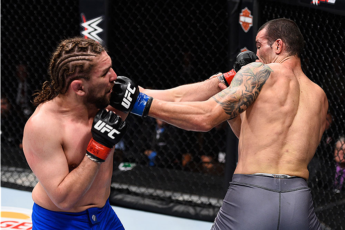 LAS VEGAS, NV - DECEMBER 11: (L-R) Chris Gruetzemacher punches Abner Lloveras in their lightweight bout during the TUF Finale event inside The Chelsea at The Cosmopolitan of Las Vegas on December 11, 2015 in Las Vegas, Nevada. (Photo by Jeff Bottari/Zuff