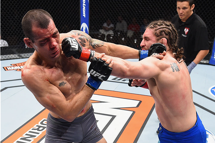LAS VEGAS, NV - DECEMBER 11: (R-L) Chris Gruetzemacher punches Abner Lloveras in their lightweight bout during the TUF Finale event inside The Chelsea at The Cosmopolitan of Las Vegas on December 11, 2015 in Las Vegas, Nevada. (Photo by Jeff Bottari/Zuff