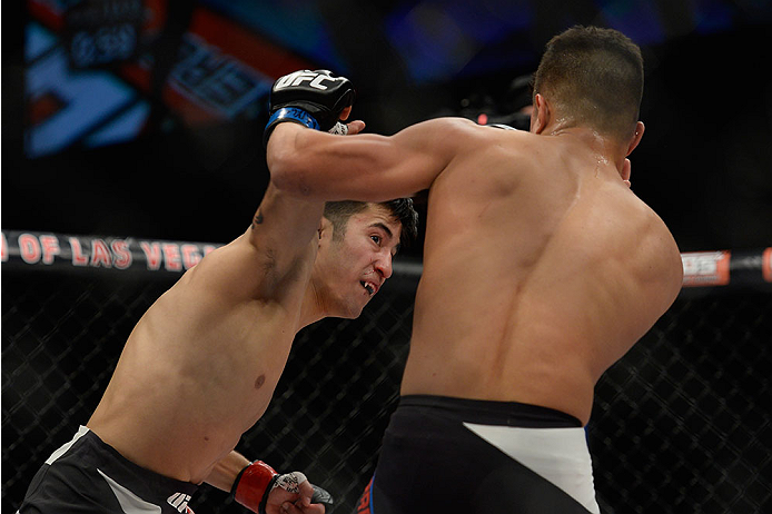 LAS VEGAS, NV - DECEMBER 11: (L-R) Joby Sanchez punches Geane Herrera in their flyweight bout during the TUF Finale event inside The Chelsea at The Cosmopolitan of Las Vegas on December 11, 2015 in Las Vegas, Nevada. (Photo by Jeff Bottari/Zuffa LLC/Zuff
