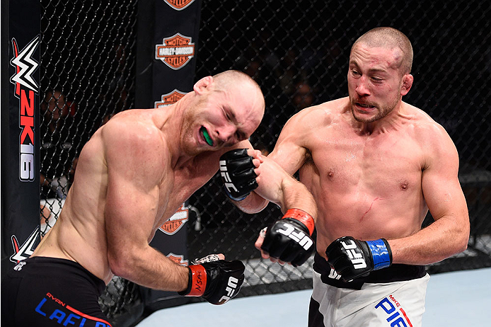 LAS VEGAS, NV - DECEMBER 11: (R-L) Mike Pierce punches Ryan LaFlare in their welterweight bout during the TUF Finale event inside The Chelsea at The Cosmopolitan of Las Vegas on December 11, 2015 in Las Vegas, Nevada. (Photo by Jeff Bottari/Zuffa LLC/Zuf