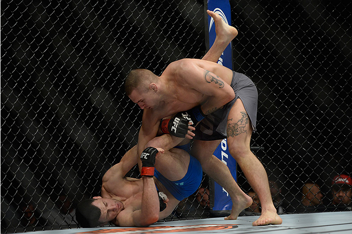 LAS VEGAS, NV - DECEMBER 11: Marcin Wrzosek (top) punches Julian Erosa in their lightweight bout during the TUF Finale event inside The Chelsea at The Cosmopolitan of Las Vegas on December 11, 2015 in Las Vegas, Nevada. (Photo by Brandon Magnus/Zuffa LLC