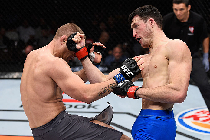 LAS VEGAS, NV - DECEMBER 11: (R-L) Julian Erosa punches Marcin Wrzosek in their lightweight bout during the TUF Finale event inside The Chelsea at The Cosmopolitan of Las Vegas on December 11, 2015 in Las Vegas, Nevada. (Photo by Jeff Bottari/Zuffa LLC/Z