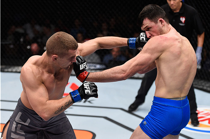LAS VEGAS, NV - DECEMBER 11: (L-R) Marcin Wrzosek punches Julian Erosa in their lightweight bout during the TUF Finale event inside The Chelsea at The Cosmopolitan of Las Vegas on December 11, 2015 in Las Vegas, Nevada. (Photo by Jeff Bottari/Zuffa LLC/Z
