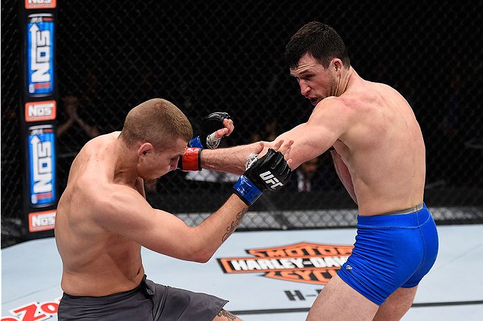 LAS VEGAS, NV - DECEMBER 11: (R-L) Julian Erosa punches Marcin Wrzosek in their lightweight bout during the TUF Finale event inside The Chelsea at The Cosmopolitan of Las Vegas on December 11, 2015 in Las Vegas, Nevada. (Photo by Jeff Bottari/Zuffa LLC/Z