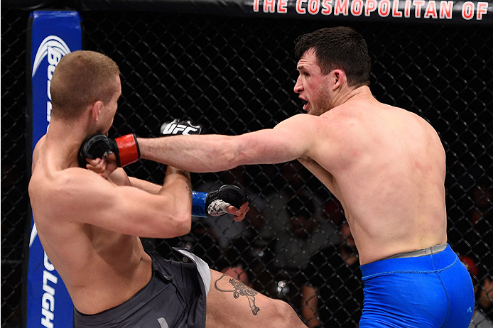 LAS VEGAS, NV - DECEMBER 11: (R-L) Julian Erosa punches Marcin Wrzosek in their lightweight bout during the TUF Finale event inside The Chelsea at The Cosmopolitan of Las Vegas on December 11, 2015 in Las Vegas, Nevada. (Photo by Jeff Bottari/Zuffa LLC/Z