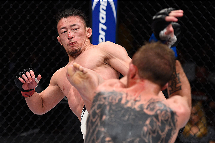 LAS VEGAS, NV - DECEMBER 11: (L-R) Tatsuya Kawajiri kicks Jason Knight in their featherweight bout during the TUF Finale event inside The Chelsea at The Cosmopolitan of Las Vegas on December 11, 2015 in Las Vegas, Nevada. (Photo by Jeff Bottari/Zuffa LLC