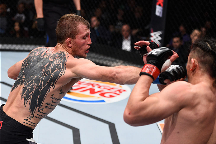 LAS VEGAS, NV - DECEMBER 11: (L-R) Jason Knight punches Tatsuya Kawajiri in their featherweight bout during the TUF Finale event inside The Chelsea at The Cosmopolitan of Las Vegas on December 11, 2015 in Las Vegas, Nevada. (Photo by Jeff Bottari/Zuffa L