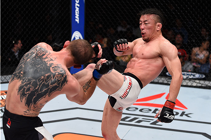 LAS VEGAS, NV - DECEMBER 11: (R-L) Tatsuya Kawajiri kicks Jason Knight in their featherweight bout during the TUF Finale event inside The Chelsea at The Cosmopolitan of Las Vegas on December 11, 2015 in Las Vegas, Nevada. (Photo by Jeff Bottari/Zuffa LL