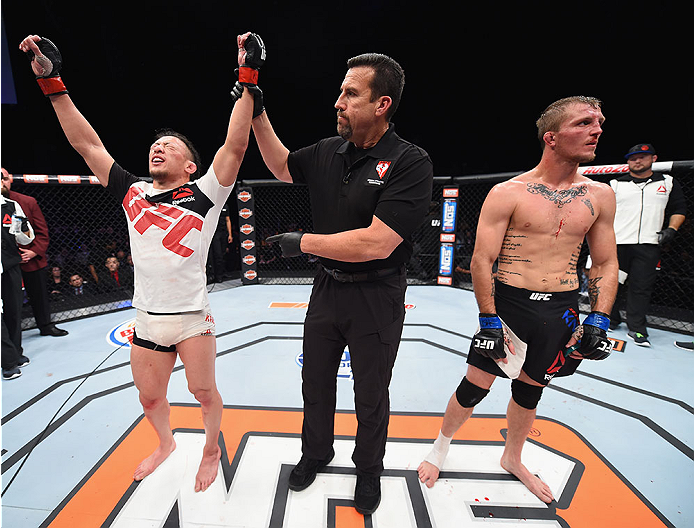 LAS VEGAS, NV - DECEMBER 11: Tatsuya Kawajiri (left) is declared the winner against Jason Knight in their featherweight bout during the TUF Finale event inside The Chelsea at The Cosmopolitan of Las Vegas on December 11, 2015 in Las Vegas, Nevada. (Photo