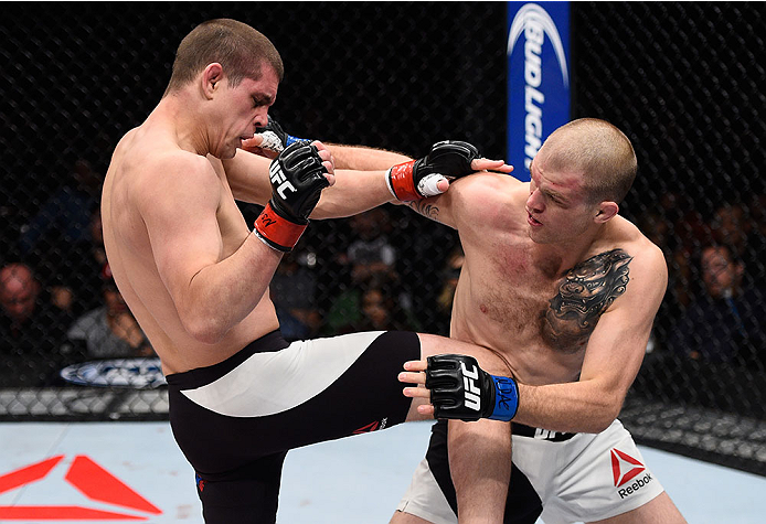 LAS VEGAS, NV - DECEMBER 11: (R-L) Evan Dunham punches Joe Lauzon in their lightweight bout during the TUF Finale event inside The Chelsea at The Cosmopolitan of Las Vegas on December 11, 2015 in Las Vegas, Nevada. (Photo by Jeff Bottari/Zuffa LLC/Zuffa