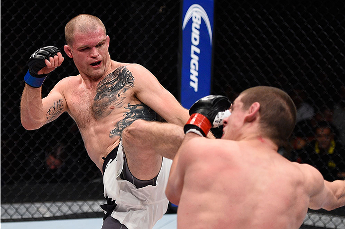 LAS VEGAS, NV - DECEMBER 11: (L-R) Evan Dunham kicks Joe Lauzon in their lightweight bout during the TUF Finale event inside The Chelsea at The Cosmopolitan of Las Vegas on December 11, 2015 in Las Vegas, Nevada. (Photo by Jeff Bottari/Zuffa LLC/Zuffa LL