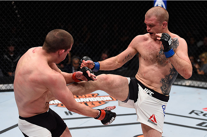 LAS VEGAS, NV - DECEMBER 11: (R-L) Evan Dunham kicks Joe Lauzon in their lightweight bout during the TUF Finale event inside The Chelsea at The Cosmopolitan of Las Vegas on December 11, 2015 in Las Vegas, Nevada. (Photo by Jeff Bottari/Zuffa LLC/Zuffa LL