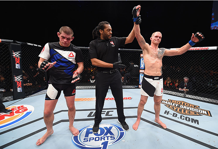 LAS VEGAS, NV - DECEMBER 11: Evan Dunham (right) is declared the winner against Joe Lauzon (left) in their lightweight bout during the TUF Finale event inside The Chelsea at The Cosmopolitan of Las Vegas on December 11, 2015 in Las Vegas, Nevada. (Photo
