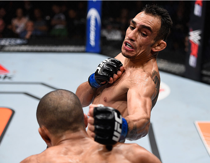 LAS VEGAS, NV - DECEMBER 11: Tony Ferguson (top) punches Edson Barboza in their lightweight bout during the TUF Finale event inside The Chelsea at The Cosmopolitan of Las Vegas on December 11, 2015 in Las Vegas, Nevada. (Photo by Jeff Bottari/Zuffa LLC/Z