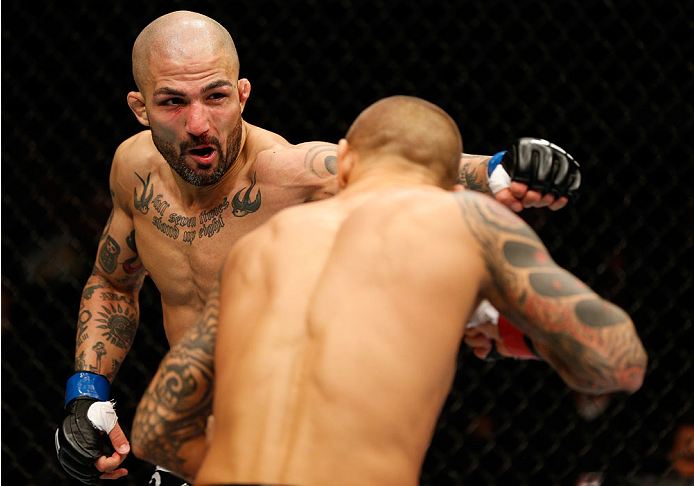 QUEBEC CITY, CANADA - APRIL 16: (L-R) Akira Corassani punches Dustin Poirier in their featherweight fight during the TUF Nations Finale at Colisee Pepsi on April 16, 2014 in Quebec City, Quebec, Canada. (Photo by Josh Hedges/Zuffa LLC/Zuffa LLC via Getty