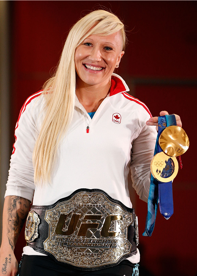 QUEBEC CITY, CANADA - APRIL 13: Canadian Olympic gold medalist Kaillie Humphries poses with the UFC belt during the UFC open workouts at the Centre Commercial Place Fleur de Lys on April 13, 2014 in Quebec City, Quebec, Canada. (Photo by Josh Hedges/Zuff