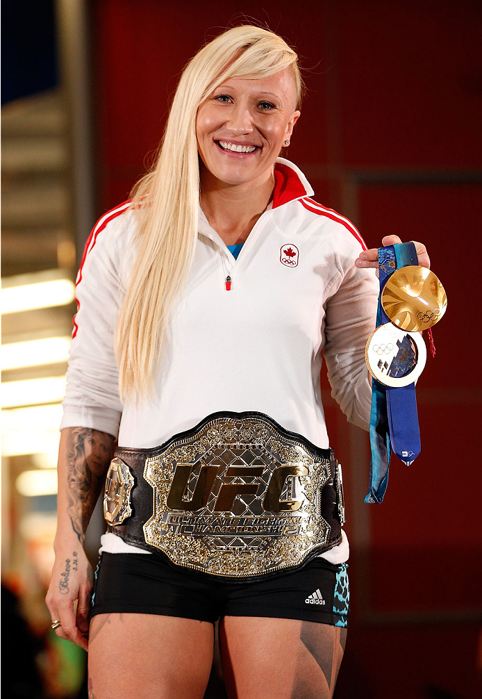 QUEBEC CITY, CANADA - APRIL 13: Canadian Olympic gold medalist Kaillie Humphries poses with the UFC belt during the UFC open workouts at the Centre Commercial Place Fleur de Lys on April 13, 2014 in Quebec City, Quebec, Canada. (Photo by Josh Hedges/Zuff