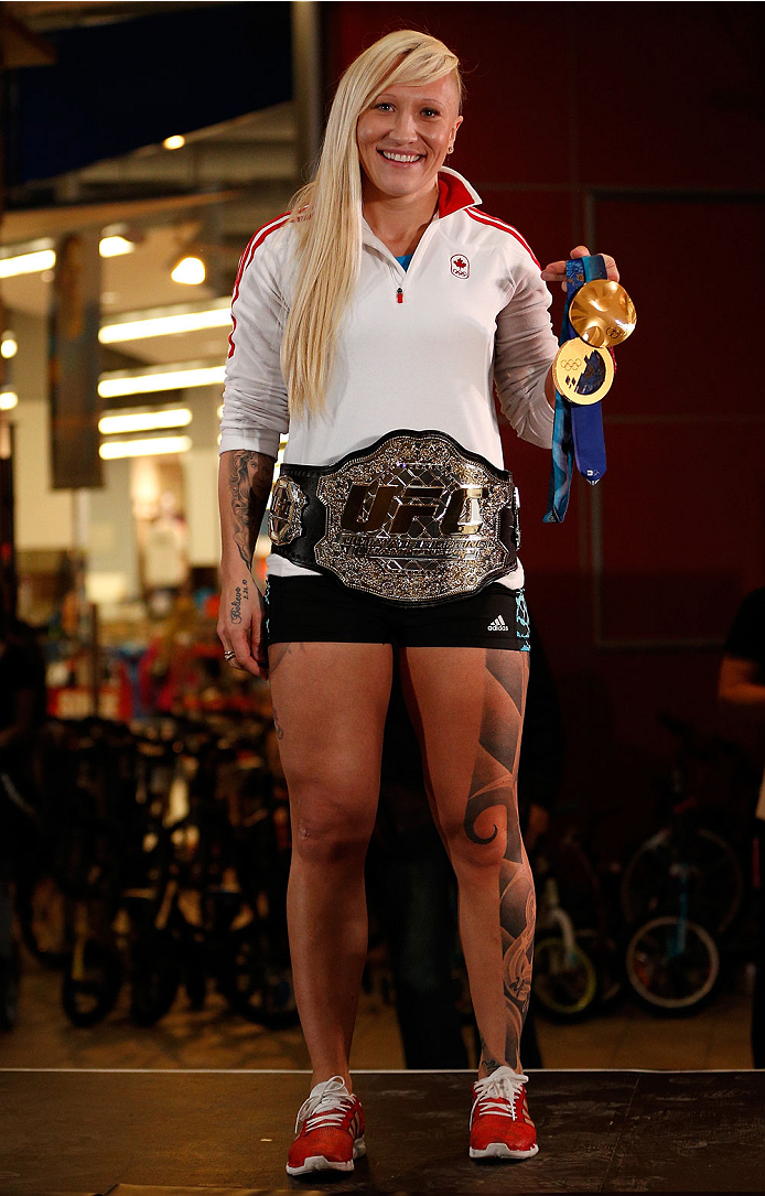 QUEBEC CITY, CANADA - APRIL 13: Canadian Olympic gold medalist Kaillie Humphries poses with the UFC belt during the UFC open workouts at the Centre Commercial Place Fleur de Lys on April 13, 2014 in Quebec City, Quebec, Canada. (Photo by Josh Hedges/Zuff