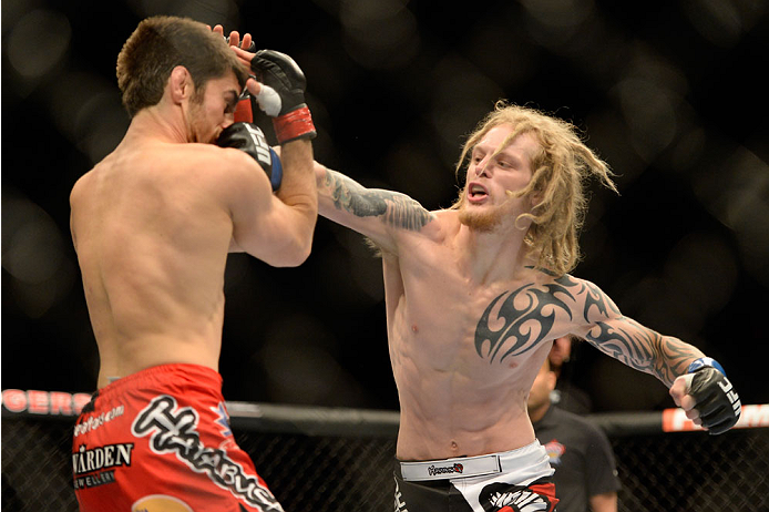 VANCOUVER, BC - JUNE 14: (R-L) Josh Shockley punches Jason Saggo during the UFC 174 event at Rogers Arena on June 14, 2014 in Vancouver, British Columbia, Canada. (Photo by Jeff Bottari/Zuffa LLC/Zuffa LLC via Getty Images)