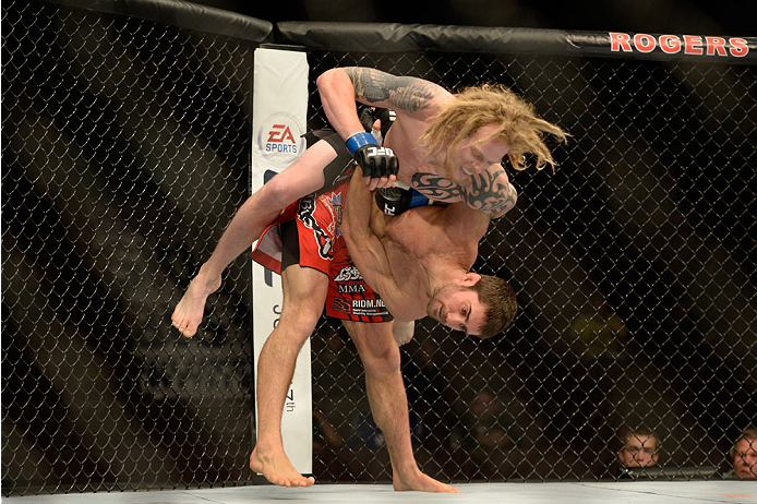 VANCOUVER, BC - JUNE 14: (R-L) Jason Saggo takes down Josh Shockley during the UFC 174 event at Rogers Arena on June 14, 2014 in Vancouver, British Columbia, Canada. (Photo by Jeff Bottari/Zuffa LLC/Zuffa LLC via Getty Images)