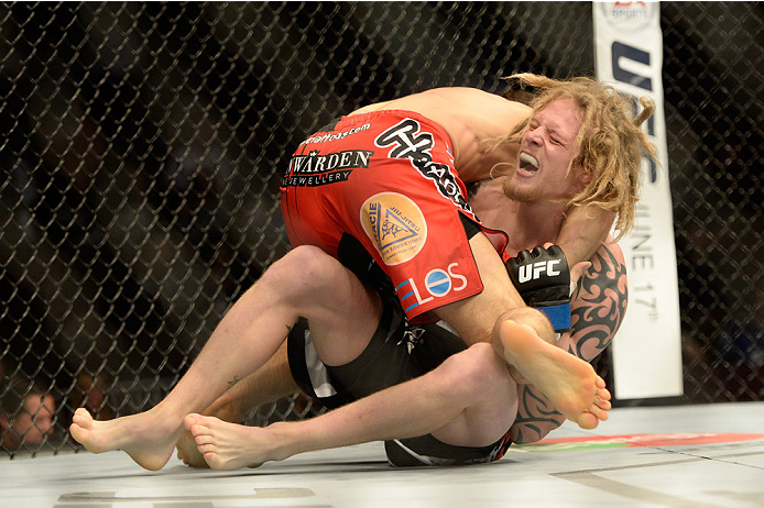 VANCOUVER, BC - JUNE 14: (L-R) Jason Saggo controls the body of Josh Shockley during the UFC 174 event at Rogers Arena on June 14, 2014 in Vancouver, British Columbia, Canada. (Photo by Jeff Bottari/Zuffa LLC/Zuffa LLC via Getty Images)