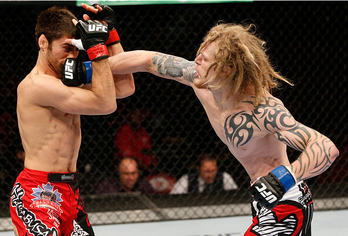 VANCOUVER, BC - JUNE 14: (R-L) Josh Shockley punches Jason Saggo in their lightweight bout at Rogers Arena on June 14, 2014 in Vancouver, Canada. (Photo by Josh Hedges/Zuffa LLC/Zuffa LLC via Getty Images)