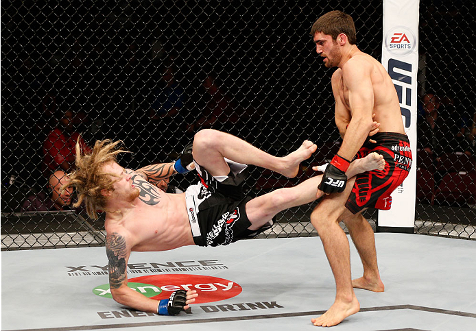 VANCOUVER, BC - JUNE 14: (R-L) Jason Saggo takes down Josh Shockley in their lightweight bout at Rogers Arena on June 14, 2014 in Vancouver, Canada. (Photo by Josh Hedges/Zuffa LLC/Zuffa LLC via Getty Images)