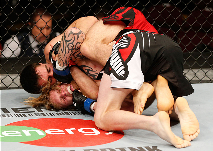 VANCOUVER, BC - JUNE 14: (R-L) Jason Saggo attempts to secure a rear choke submission against Josh Shockley in their lightweight bout at Rogers Arena on June 14, 2014 in Vancouver, Canada. (Photo by Josh Hedges/Zuffa LLC/Zuffa LLC via Getty Images)