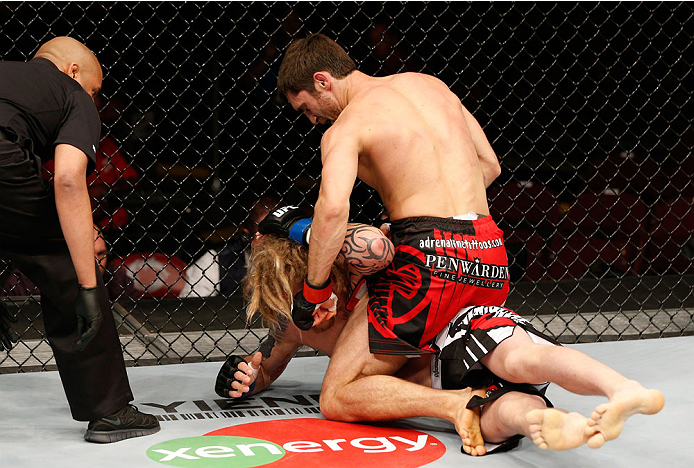 VANCOUVER, BC - JUNE 14: (R-L) Jason Saggo punches Josh Shockley in their lightweight bout at Rogers Arena on June 14, 2014 in Vancouver, Canada. (Photo by Josh Hedges/Zuffa LLC/Zuffa LLC via Getty Images)