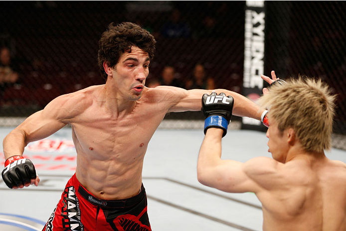 VANCOUVER, BC - JUNE 14: (L-R) Roland Delorme punches Michinori Tanaka in their bantamweight bout at Rogers Arena on June 14, 2014 in Vancouver, Canada. (Photo by Josh Hedges/Zuffa LLC/Zuffa LLC via Getty Images)