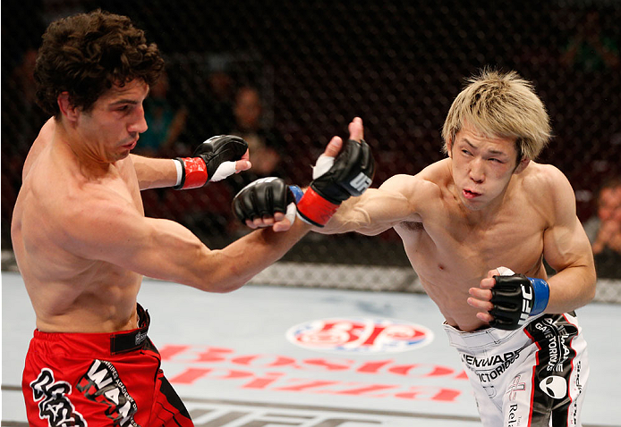 VANCOUVER, BC - JUNE 14: (R-L) Michinori Tanaka punches Roland Delorme in their bantamweight bout at Rogers Arena on June 14, 2014 in Vancouver, Canada. (Photo by Josh Hedges/Zuffa LLC/Zuffa LLC via Getty Images)