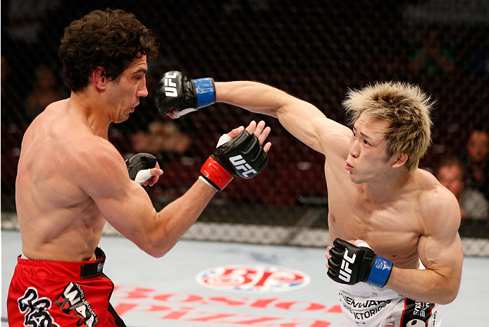 VANCOUVER, BC - JUNE 14: (R-L) Michinori Tanaka punches Roland Delorme in their bantamweight bout at Rogers Arena on June 14, 2014 in Vancouver, Canada. (Photo by Josh Hedges/Zuffa LLC/Zuffa LLC via Getty Images)