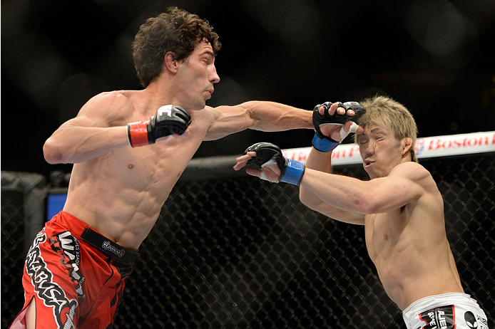 VANCOUVER, BC - JUNE 14: (L-R) Roland Delorme punches Michinori Tanaka during the UFC 174 event at Rogers Arena on June 14, 2014 in Vancouver, British Columbia, Canada. (Photo by Jeff Bottari/Zuffa LLC/Zuffa LLC via Getty Images)