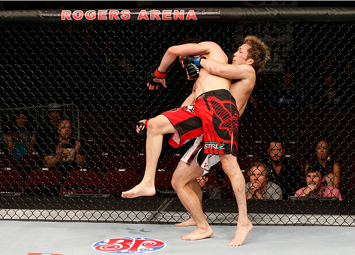 VANCOUVER, BC - JUNE 14: (R-L) Michinori Tanaka attempts to take down Roland Delorme in their bantamweight bout at Rogers Arena on June 14, 2014 in Vancouver, Canada. (Photo by Josh Hedges/Zuffa LLC/Zuffa LLC via Getty Images)