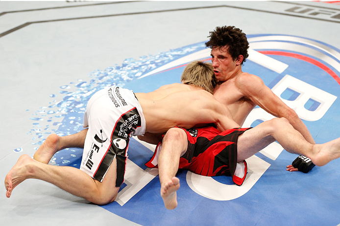 VANCOUVER, BC - JUNE 14: (L-R) Michinori Tanaka takes down Roland Delorme in their bantamweight bout at Rogers Arena on June 14, 2014 in Vancouver, Canada. (Photo by Josh Hedges/Zuffa LLC/Zuffa LLC via Getty Images)