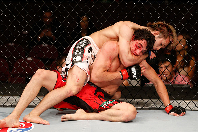 VANCOUVER, BC - JUNE 14: (L-R) Michinori Tanaka attempts to secure a rear choke against Roland Delorme in their bantamweight bout at Rogers Arena on June 14, 2014 in Vancouver, Canada. (Photo by Josh Hedges/Zuffa LLC/Zuffa LLC via Getty Images)