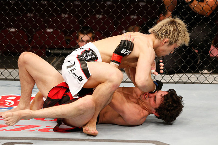 VANCOUVER, BC - JUNE 14: (L-R) Michinori Tanaka elbows Roland Delorme in their bantamweight bout at Rogers Arena on June 14, 2014 in Vancouver, Canada. (Photo by Josh Hedges/Zuffa LLC/Zuffa LLC via Getty Images)