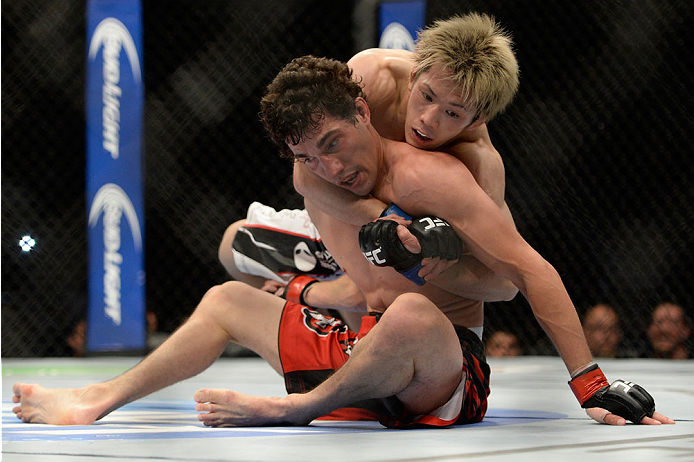 VANCOUVER, BC - JUNE 14: (L-R) Michinori Tanaka controls the body of Roland Delorme during the UFC 174 event at Rogers Arena on June 14, 2014 in Vancouver, British Columbia, Canada. (Photo by Jeff Bottari/Zuffa LLC/Zuffa LLC via Getty Images)