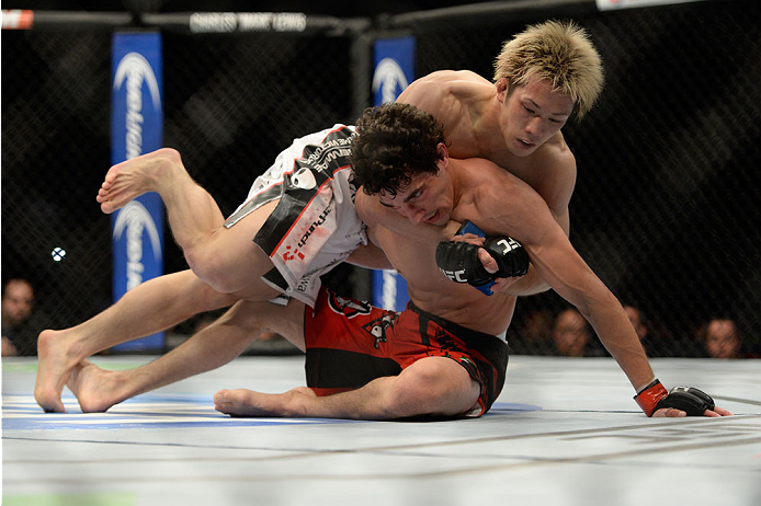 VANCOUVER, BC - JUNE 14: (L-R) Michinori Tanaka controls the body of Roland Delorme during the UFC 174 event at Rogers Arena on June 14, 2014 in Vancouver, British Columbia, Canada. (Photo by Jeff Bottari/Zuffa LLC/Zuffa LLC via Getty Images)