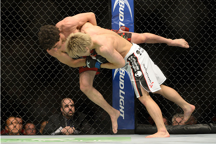 VANCOUVER, BC - JUNE 14: (R-L) Michinori Tanaka takes down Roland Delorme during the UFC 174 event at Rogers Arena on June 14, 2014 in Vancouver, British Columbia, Canada. (Photo by Jeff Bottari/Zuffa LLC/Zuffa LLC via Getty Images)