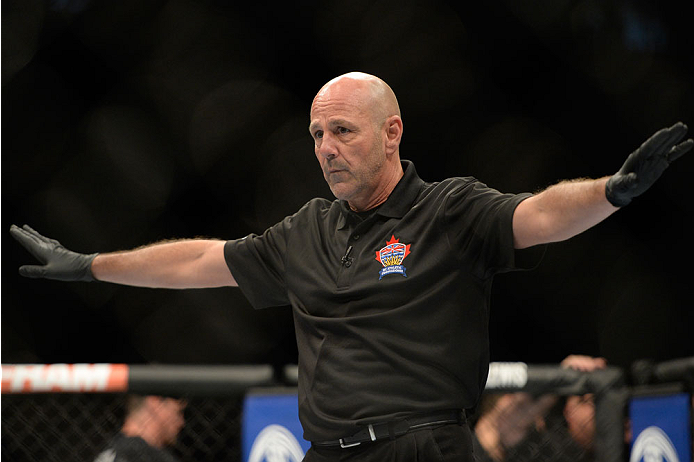 VANCOUVER, BC - JUNE 14: Referee Yves Lavigne calls the Michinori Tanaka and Roland Delorme fight during the UFC 174 event at Rogers Arena on June 14, 2014 in Vancouver, British Columbia, Canada. (Photo by Jeff Bottari/Zuffa LLC/Zuffa LLC via Getty Image